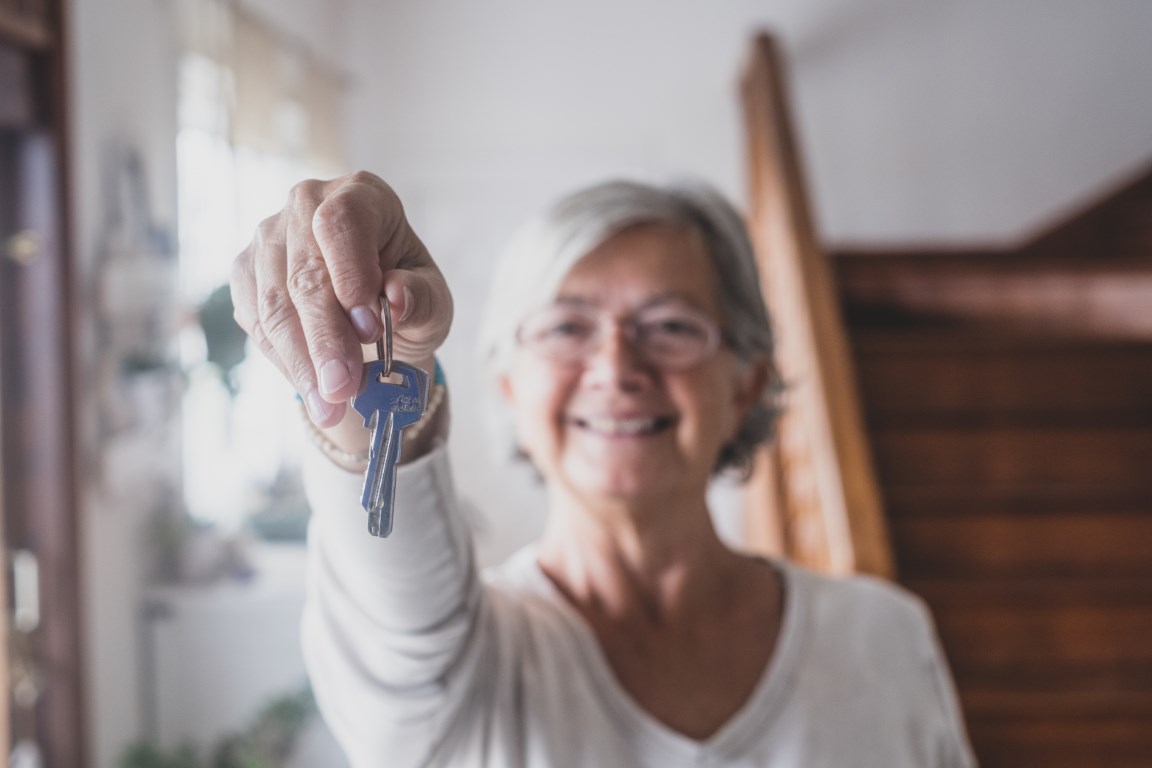 happy senior old aged woman customer landlord hold 2021 09 02 10 32 17 utc