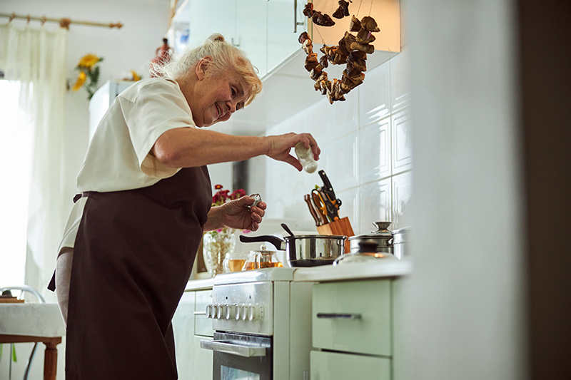 joyful senior woman in apron cooking dinner in kit 2021 09 03 10 16 10 utc