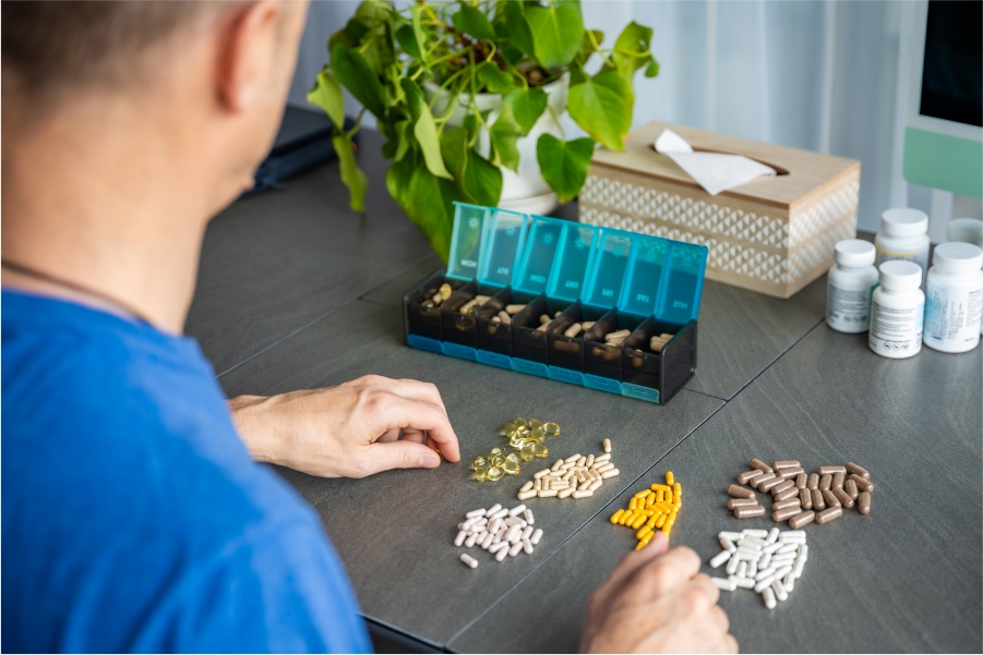 man-sorting-pills-and-supplements.jpg