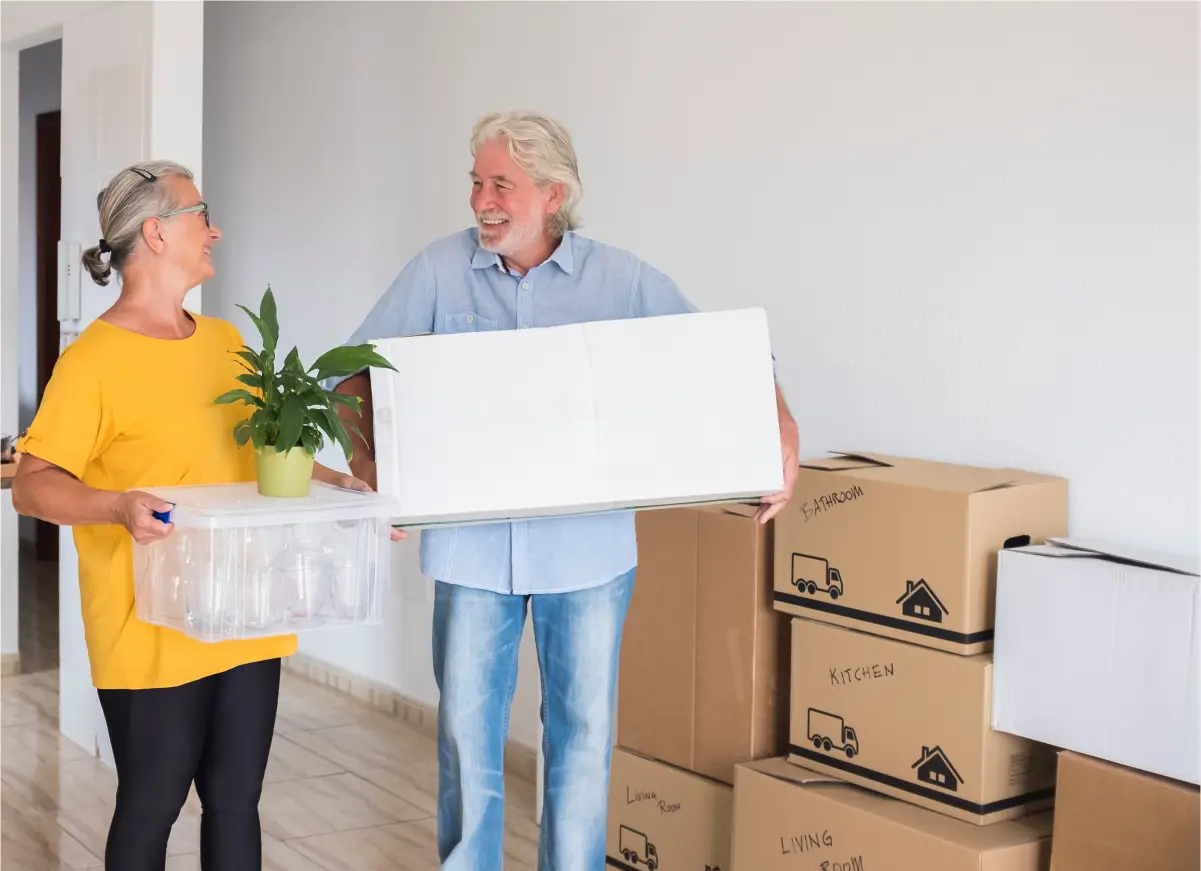 a man and a woman holding a box of boxes