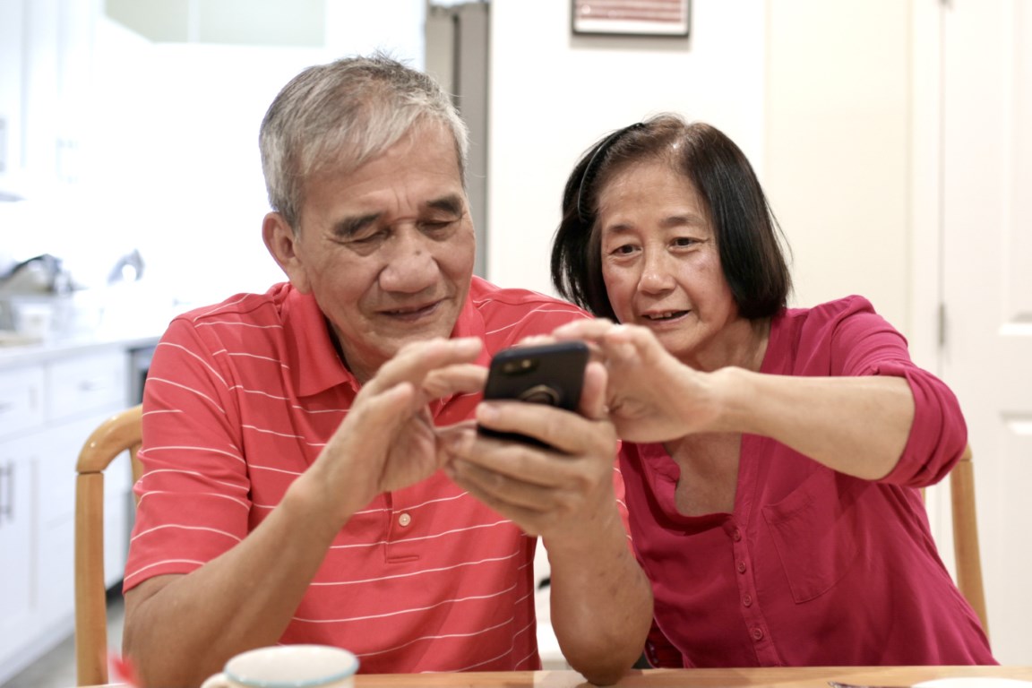 senior asian couple using a cell phone together 2022 10 31 22 09 25 utc