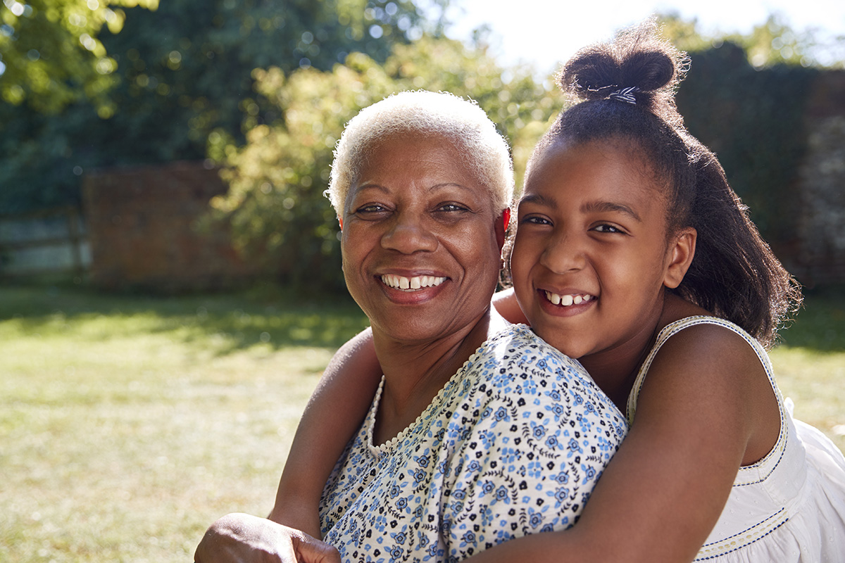 senior black woman and granddaughter sit embracing 2021 08 26 16 15 17 utc