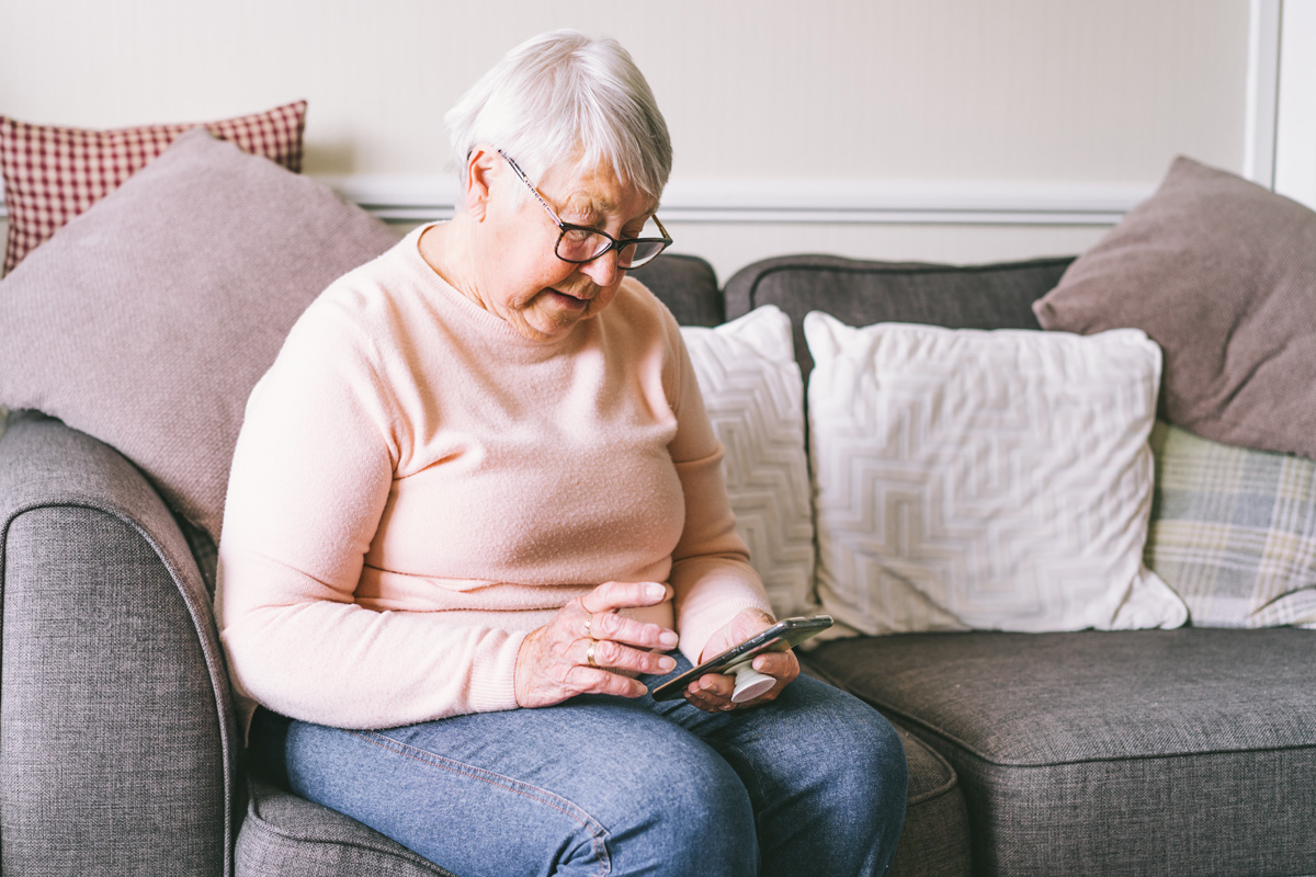 senior woman using smartphone to look for senior apartments