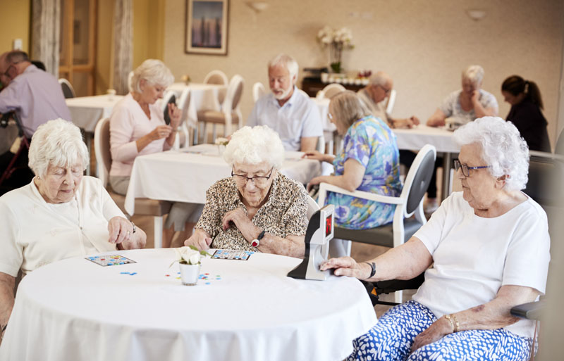 seniors playing game of bingo in independent senior apartment